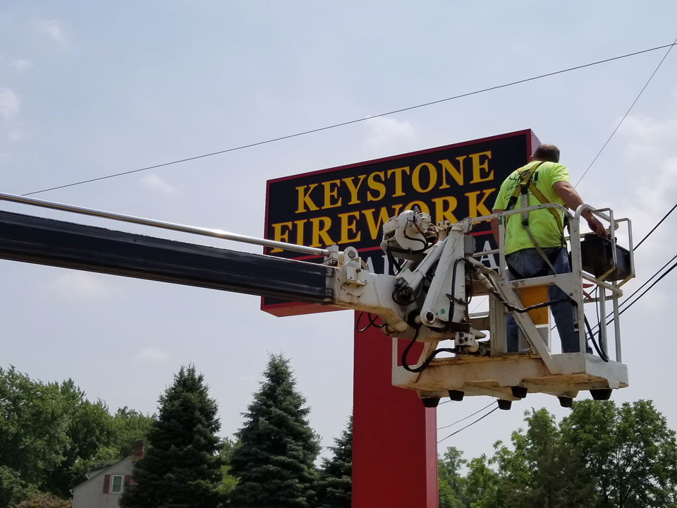 a man working on Pylon Signs in New Castle, PA, Wilmington, DE, Boardman, OH, Newark, DE, Hockessing, DE, Hermitage, PA