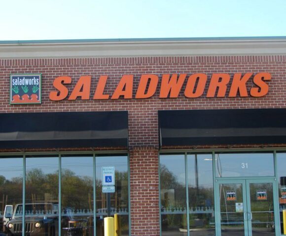  a brick building showcasing SALADWORKS Business Awning and Commercial Canopies in Mt. Jackson, PA