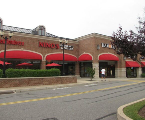 a brick and red building showcasing Commercial Canopies, Business Signs, and Vehicle Vinyl Wraps in Chatham, PA